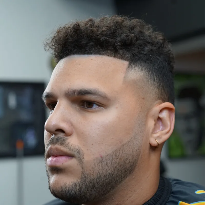 Curly top with a skin fade by RJ Williams at The Hause of Fades in Fort Myers